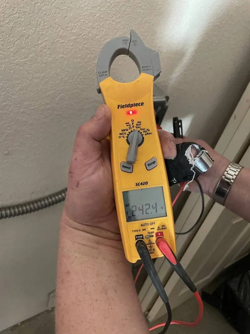 Voltage testing with clamp meter during Outlet Installation in Elm Springs